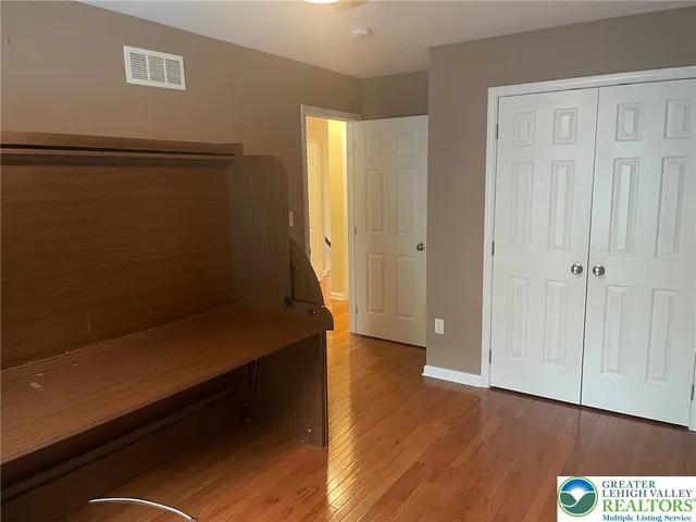 a view of hallway with wooden floor
