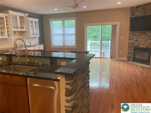 a kitchen with granite countertop a stove a sink and a granite counter top