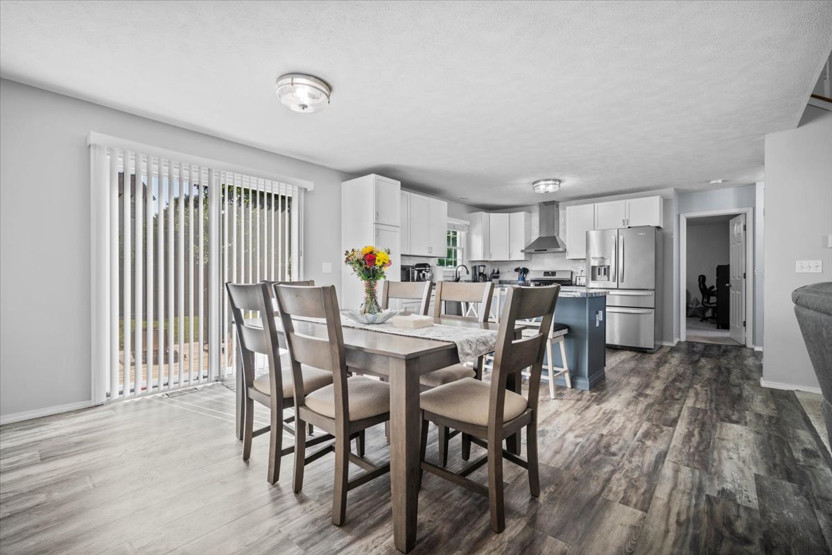 1509 Torrey Pines Road Normal, IL 61761 - Photo 12 of 36 a view of a dining room with furniture and wooden floor