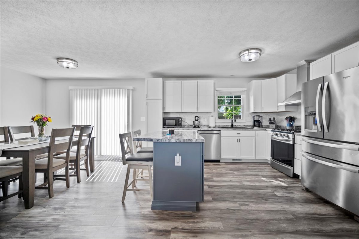1509 Torrey Pines Road Normal, IL 61761 - Photo 13 of 36 a kitchen with white cabinets stainless steel appliances and dining table