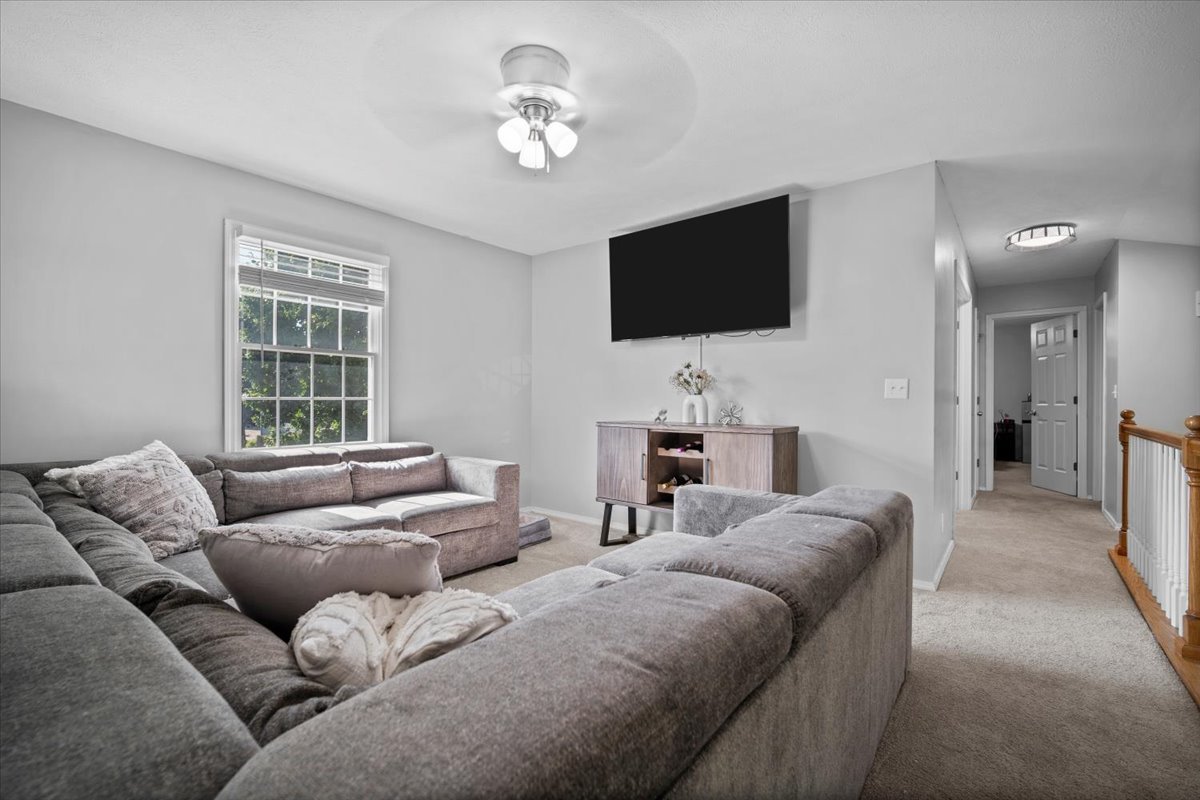 1509 Torrey Pines Road Normal, IL 61761 - Photo 20 of 36 a living room with furniture a flat screen tv and a window