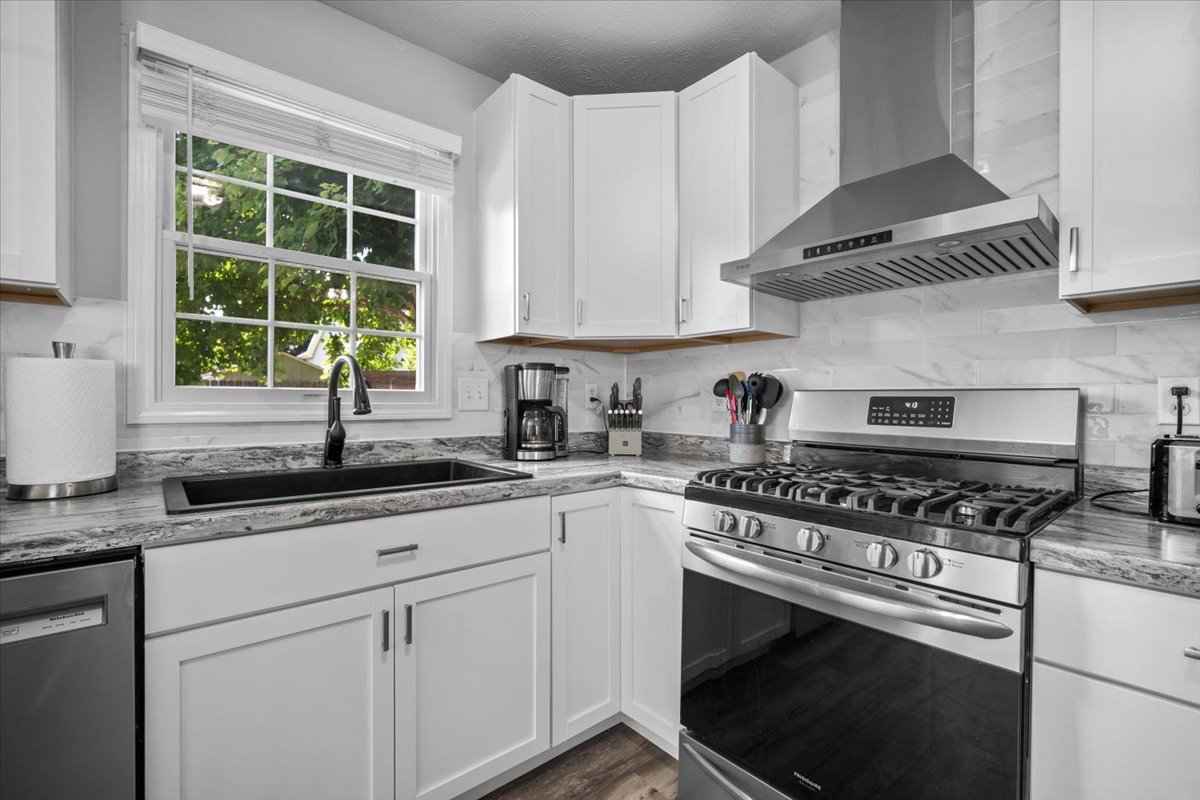 1509 Torrey Pines Road Normal, IL 61761 - Photo 10 of 36 a kitchen with granite countertop stainless steel appliances a sink stove and white cabinets