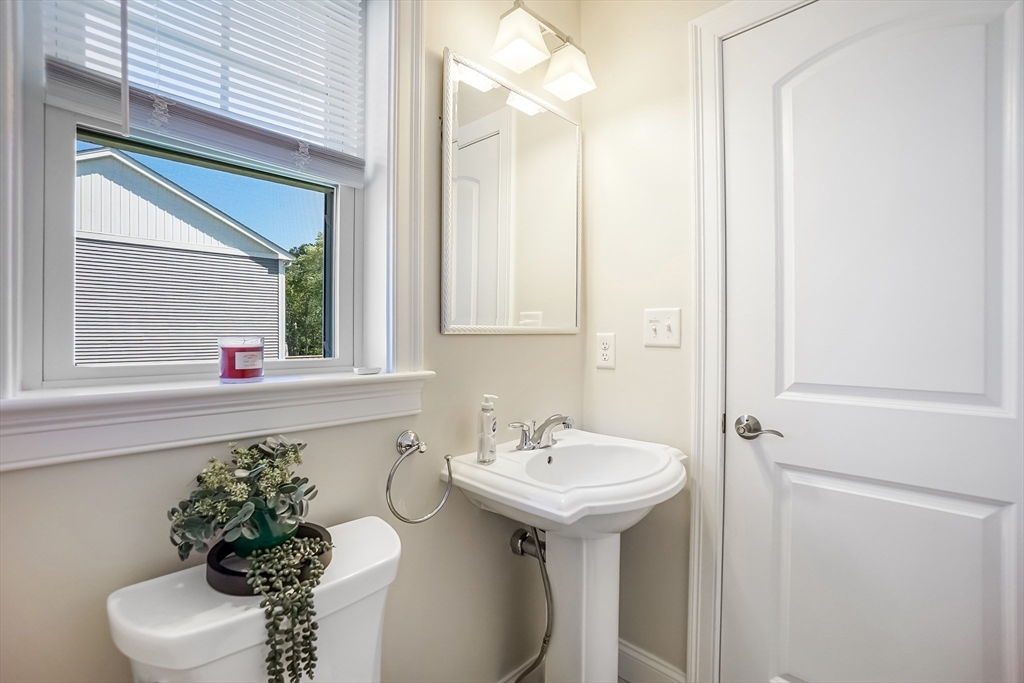 55 Plymouth Street, Unit A5 Whitman, MA 02382 - Photo 11 of 34 a bathroom with a sink toilet and a mirror