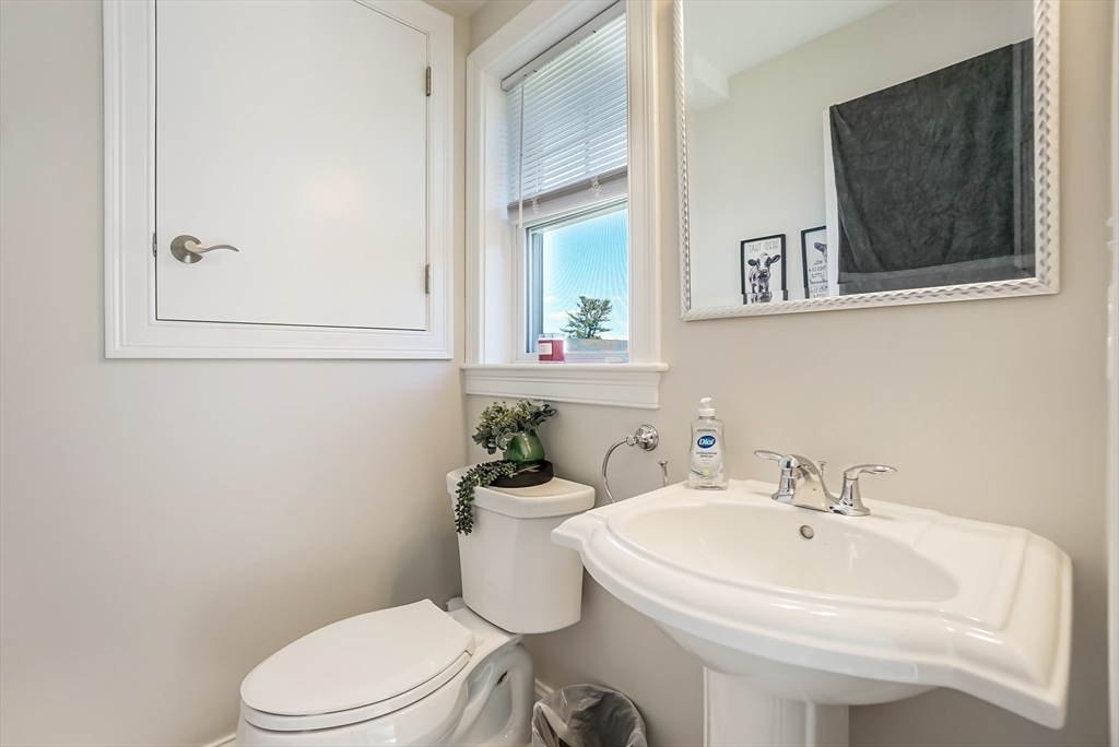 55 Plymouth Street, Unit A5 Whitman, MA 02382 - Photo 12 of 34 a white toilet sitting next to a bathroom sink
