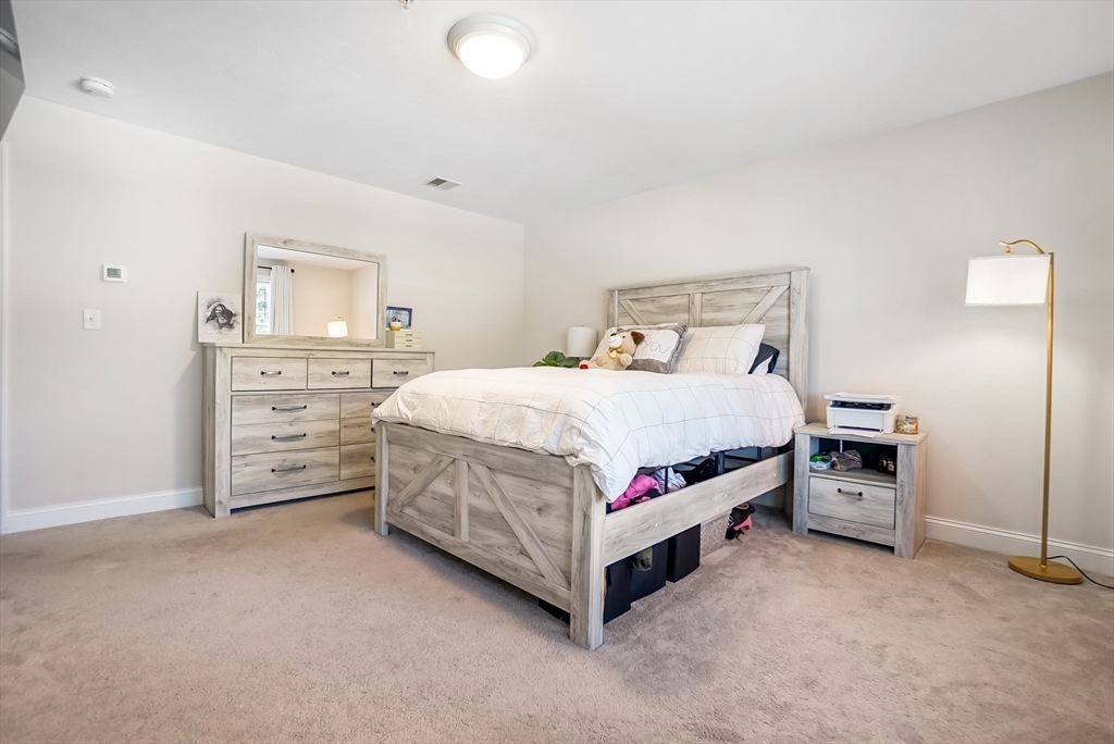 55 Plymouth Street, Unit A5 Whitman, MA 02382 - Photo 17 of 34 a bedroom with a bed and dresser