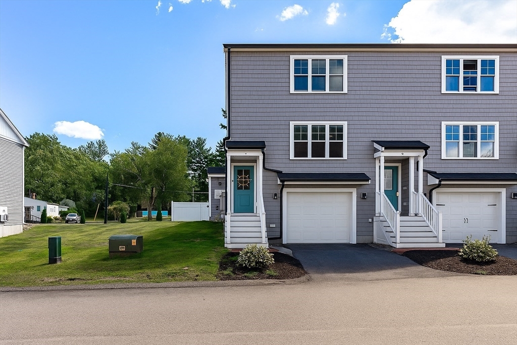 55 Plymouth Street, Unit A5 Whitman, MA 02382 - Photo 2 of 34 a front view of house with yard and green space