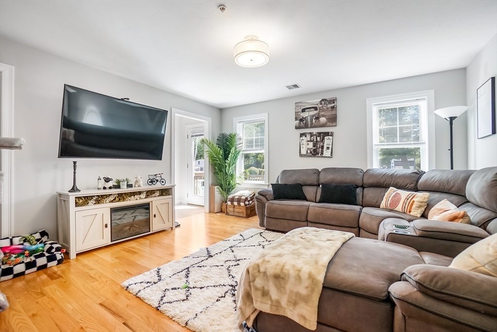 55 Plymouth Street, Unit A5 Whitman, MA 02382 - Photo 7 of 34 a living room with furniture and a flat screen tv