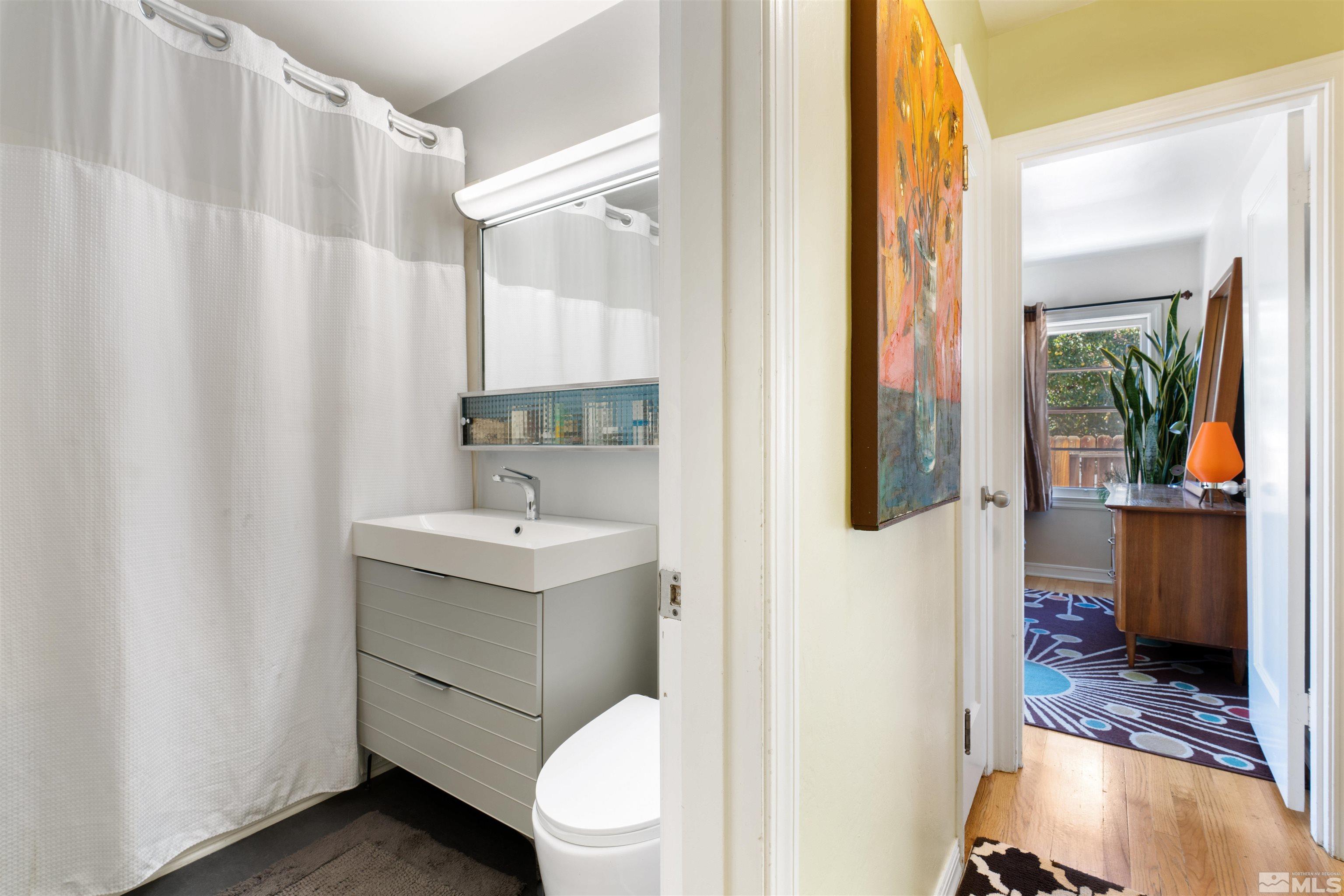704 Balzar Circle Reno, NV 89502 - Photo 18 of 32 a bathroom with a sink a toilet and shower
