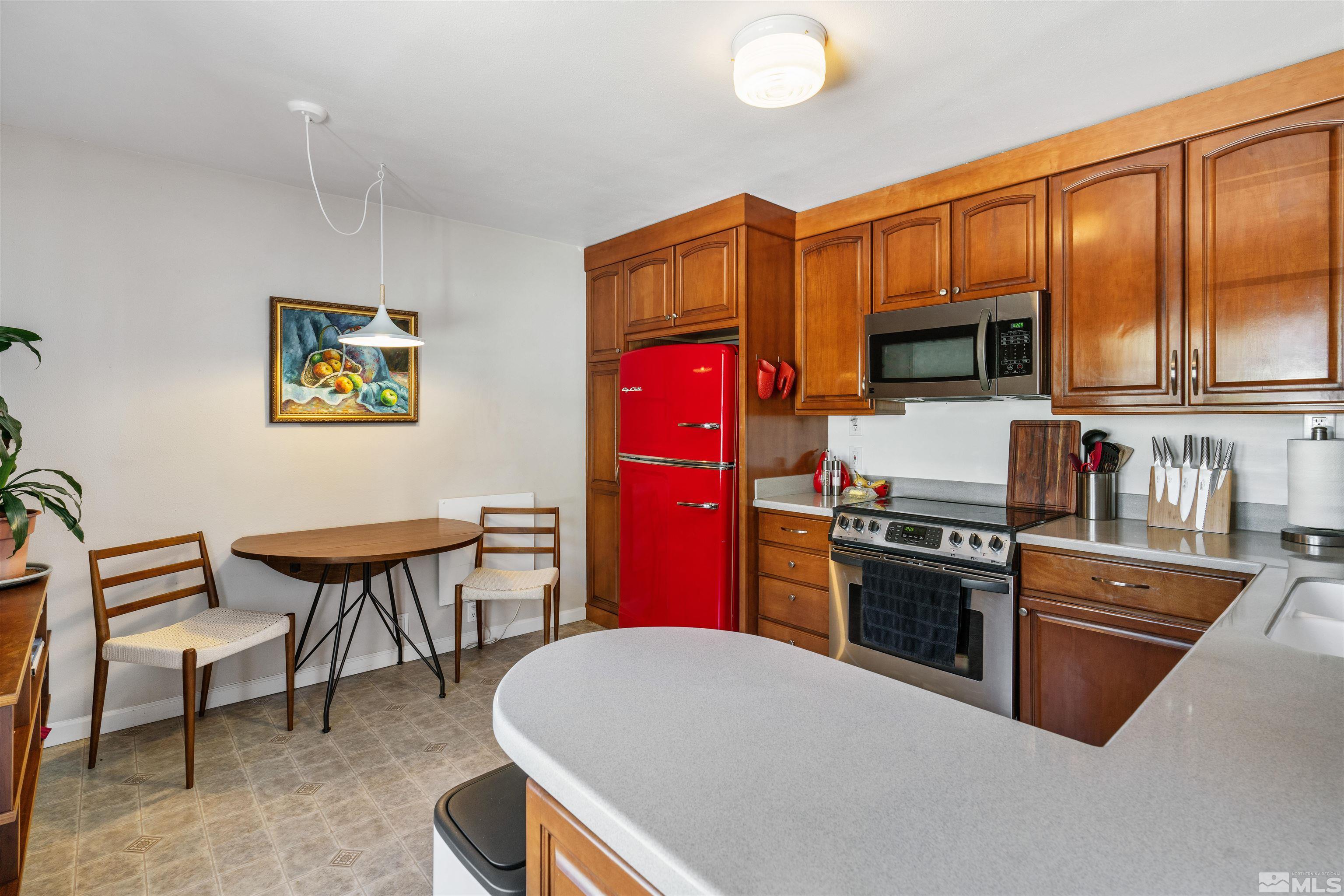 704 Balzar Circle Reno, NV 89502 - Photo 8 of 32 a kitchen with stainless steel appliances granite countertop a stove top oven a sink dishwasher and a microwave