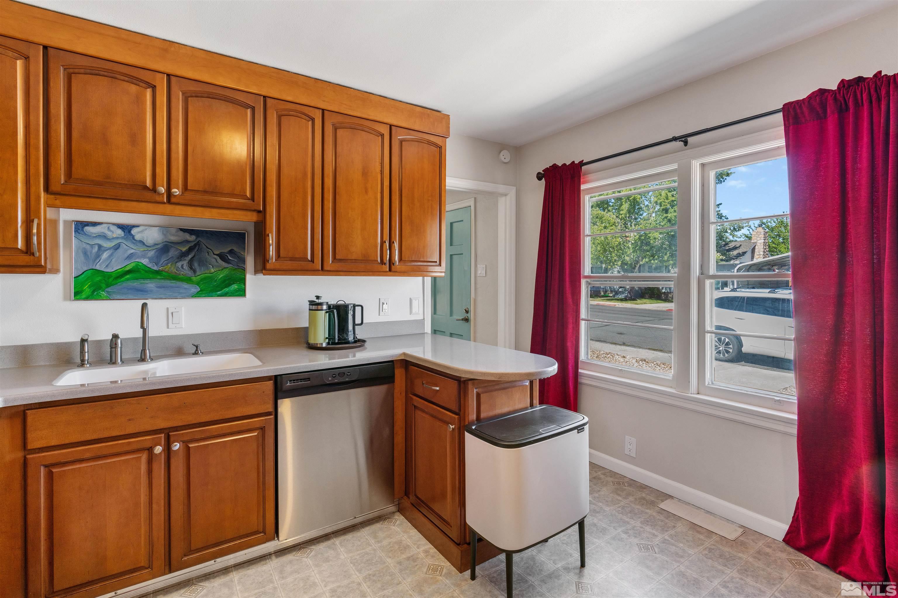 704 Balzar Circle Reno, NV 89502 - Photo 10 of 32 a kitchen with a sink cabinets and window