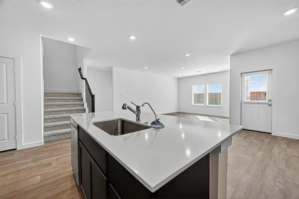 a large kitchen with stainless steel appliances granite countertop a stove and a refrigerator