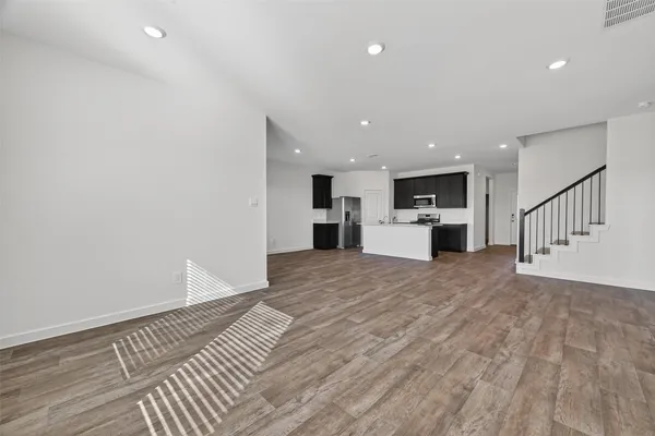 a view of an empty room with a kitchen
