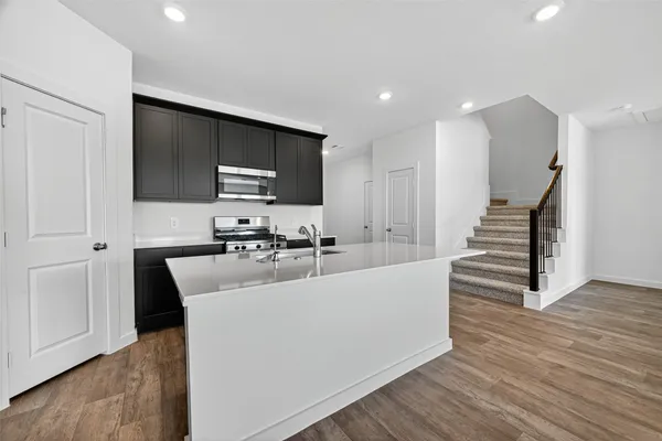 a kitchen with wooden cabinets and a stove top oven