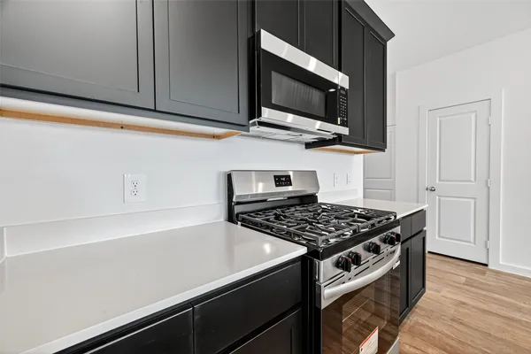 a kitchen with sink cabinets and wooden floor