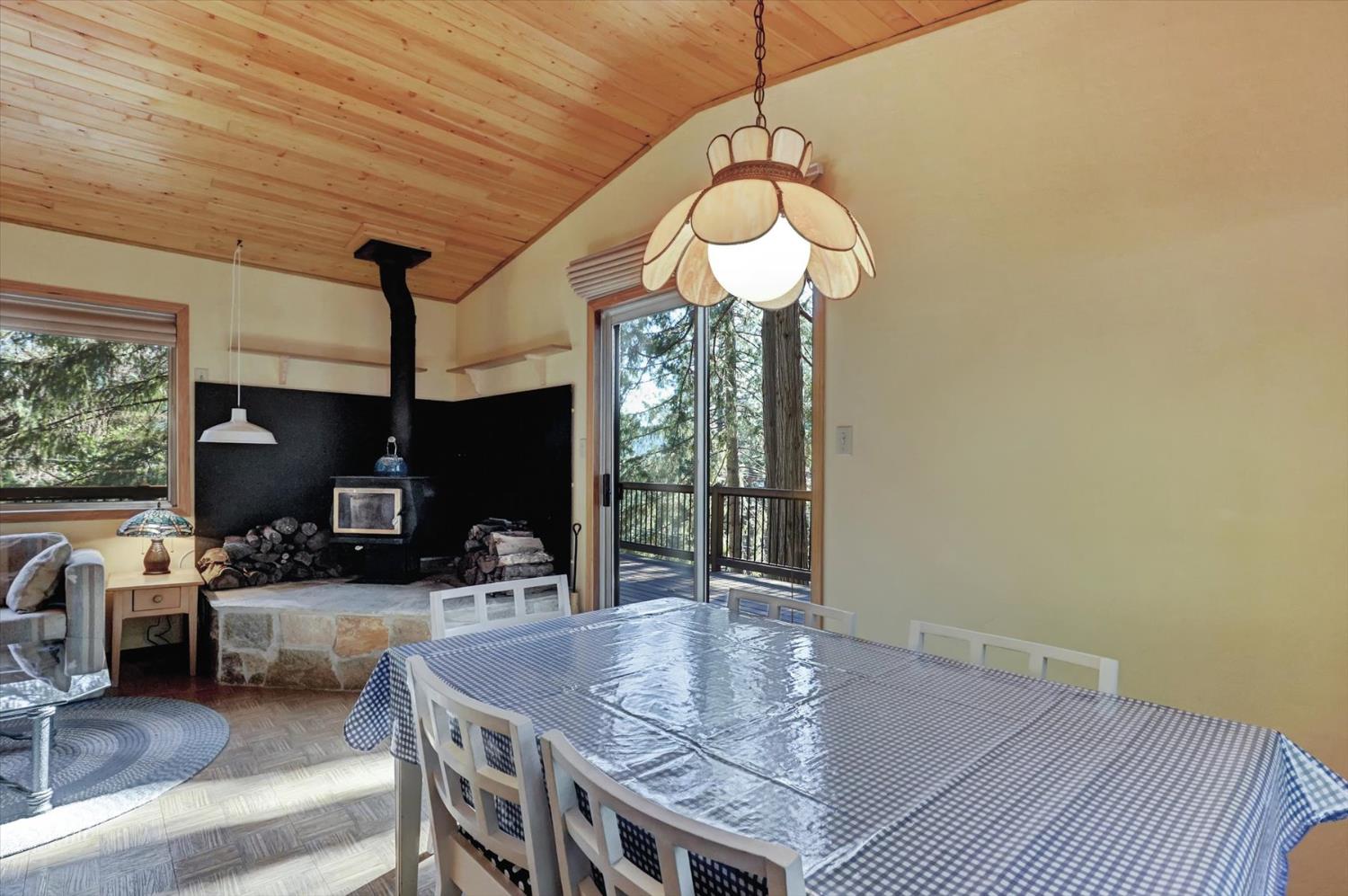 17028 Banner Quaker Hill Road Nevada City, CA 95959 - Photo 12 of 79 a view of a dining room with furniture wooden floor and chandelier
