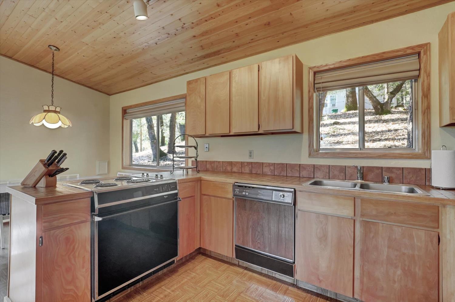 17028 Banner Quaker Hill Road Nevada City, CA 95959 - Photo 18 of 79 a kitchen with stainless steel appliances granite countertop a sink stove and cabinets
