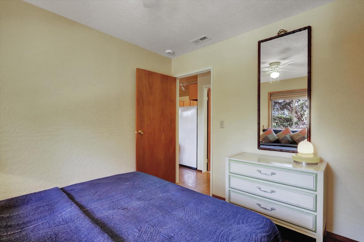 17028 Banner Quaker Hill Road Nevada City, CA 95959 - Photo 26 of 79 a bedroom with a bed and a dresser in it