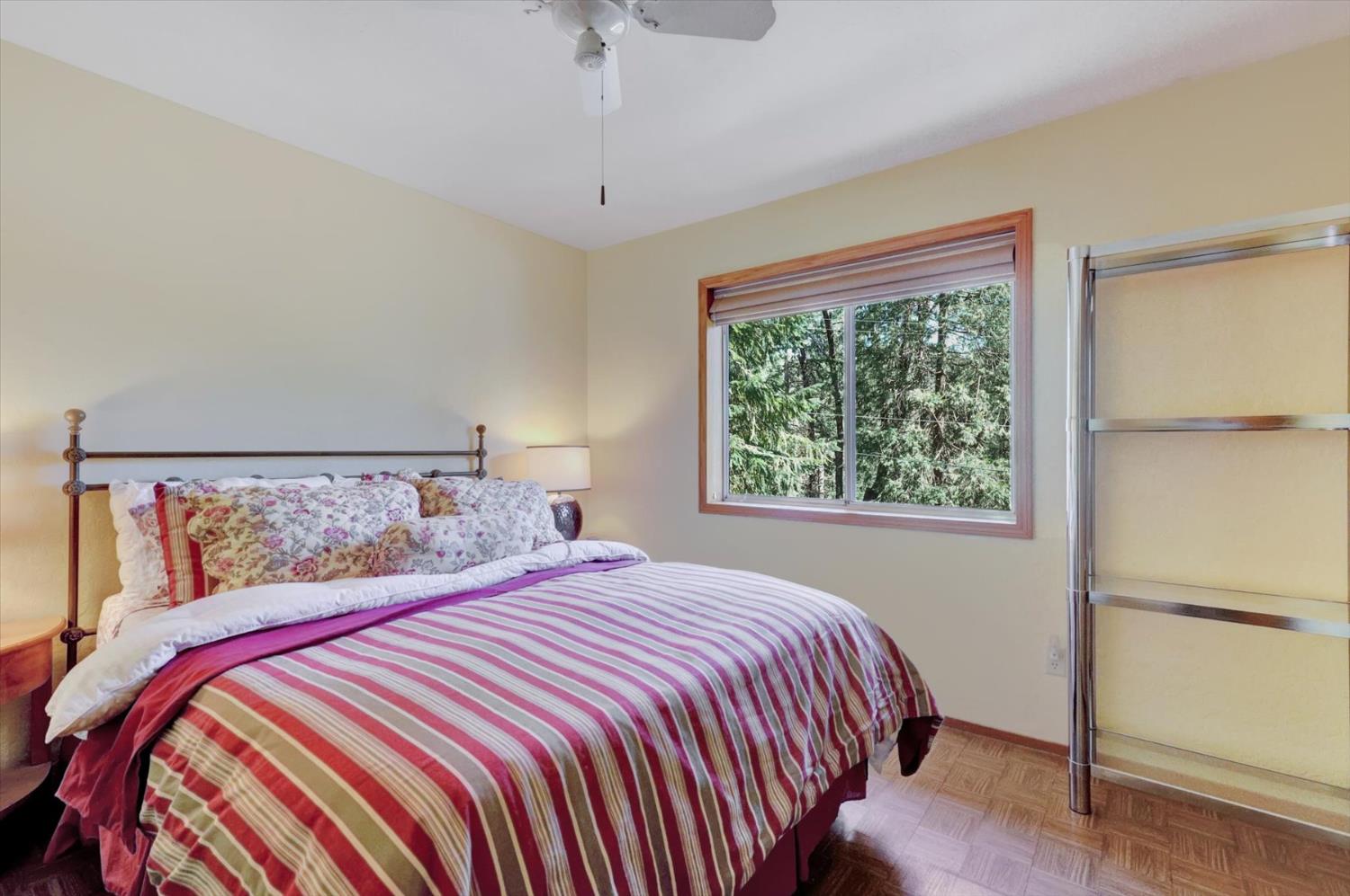 17028 Banner Quaker Hill Road Nevada City, CA 95959 - Photo 30 of 79 a bedroom with a large bed and a window