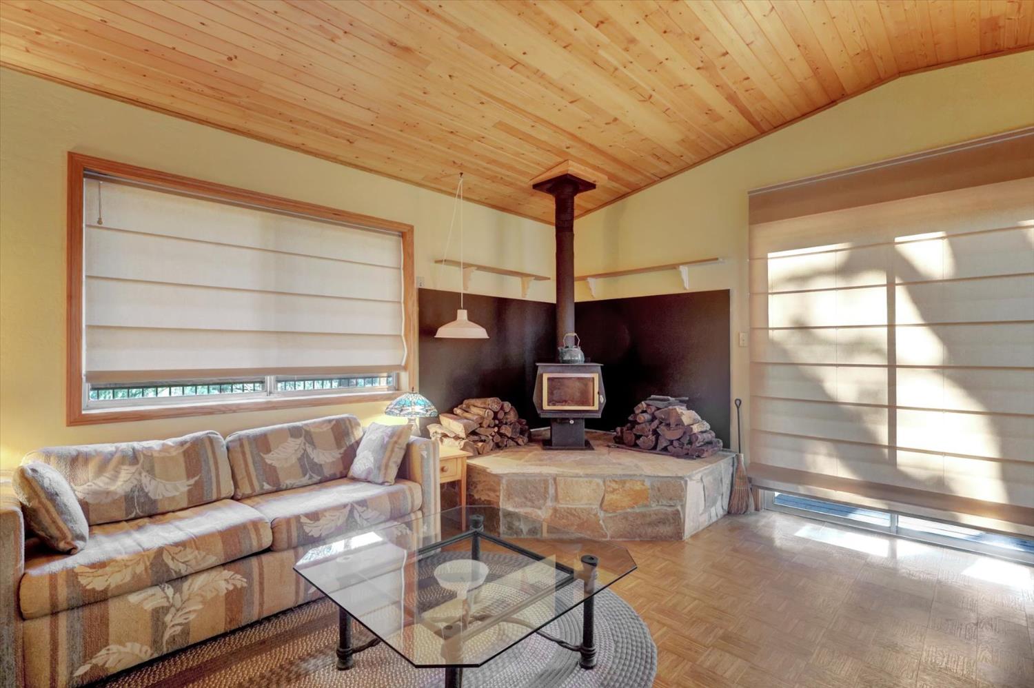 17028 Banner Quaker Hill Road Nevada City, CA 95959 - Photo 4 of 79 a living room with furniture and a flat screen tv