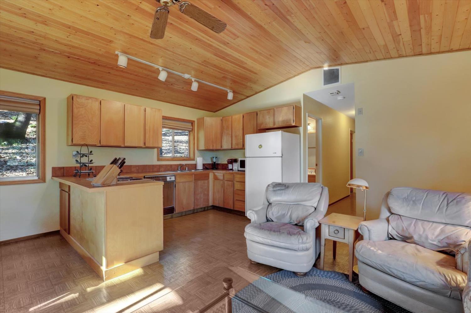 17028 Banner Quaker Hill Road Nevada City, CA 95959 - Photo 6 of 79 a living room with furniture and a refrigerator