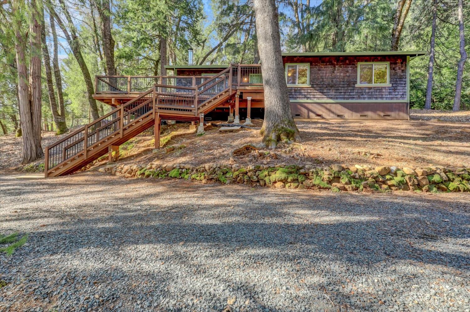 17028 Banner Quaker Hill Road Nevada City, CA 95959 - Photo 74 of 79 a backyard of a house with barbeque oven table and chairs