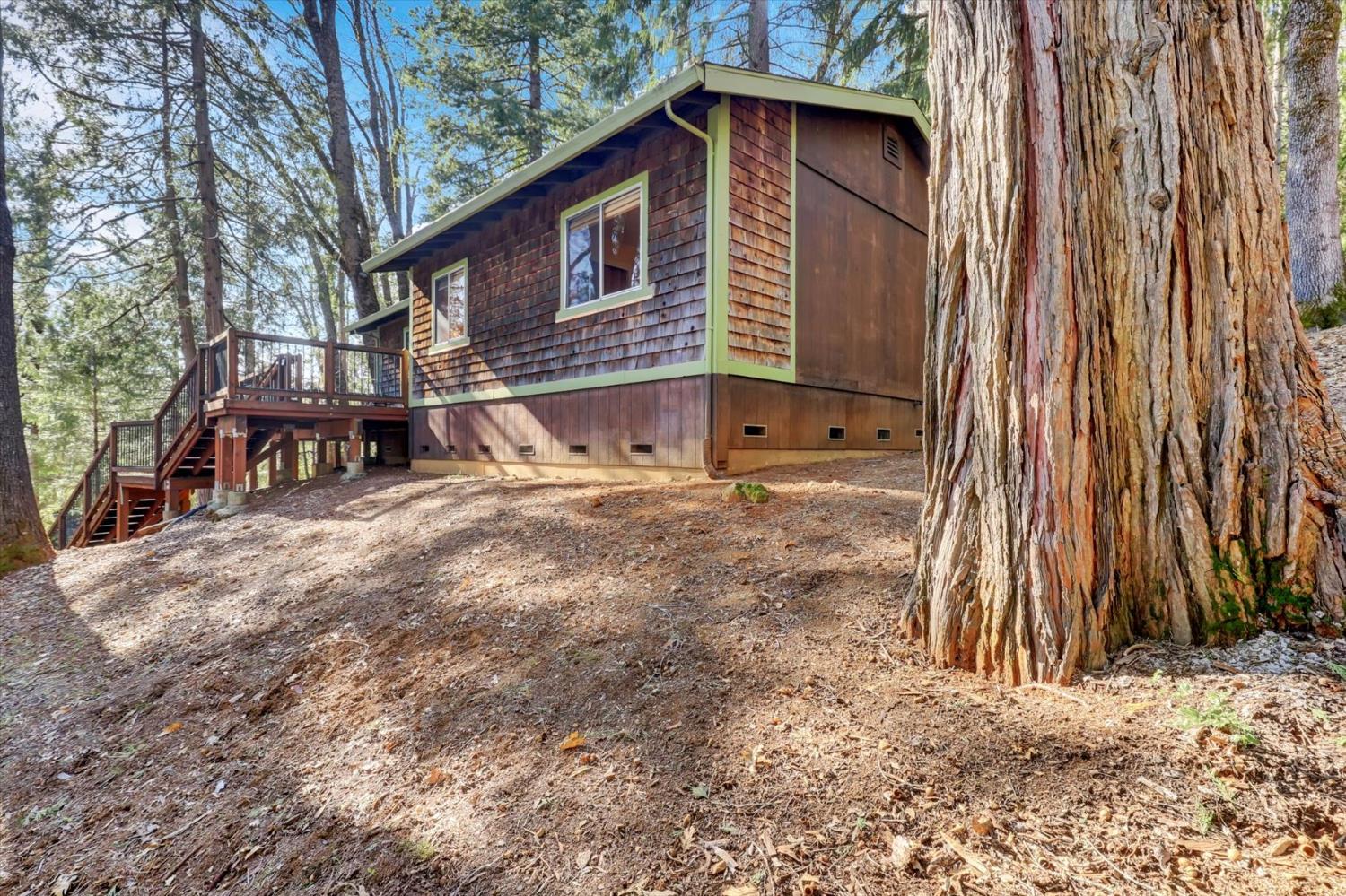 17028 Banner Quaker Hill Road Nevada City, CA 95959 - Photo 76 of 79 a view of a house with a yard and wooden fence