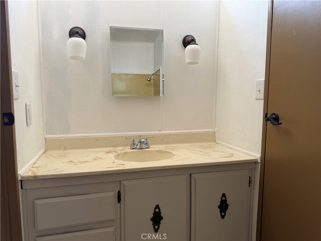 148600 Panoply Road Needles, CA 92363 - Photo 13 of 32 a bathroom with a sink and mirror
