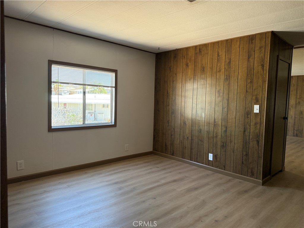 148600 Panoply Road Needles, CA 92363 - Photo 15 of 32 an empty room with wooden floor and windows