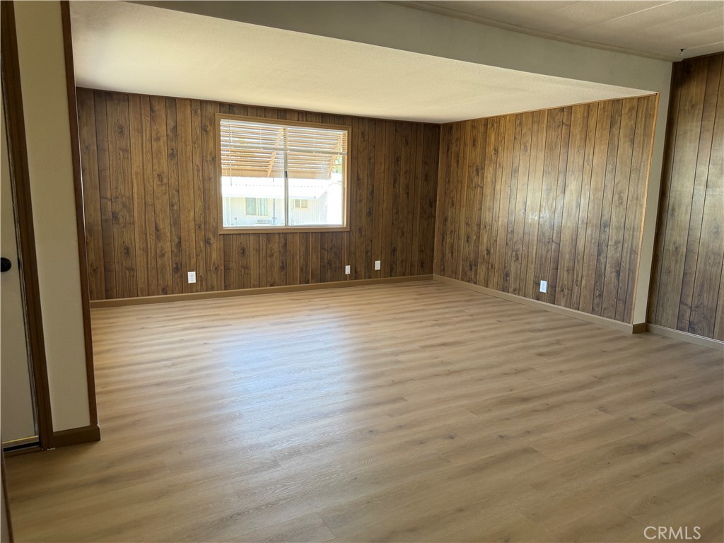 148600 Panoply Road Needles, CA 92363 - Photo 18 of 32 an empty room with wooden floor and windows