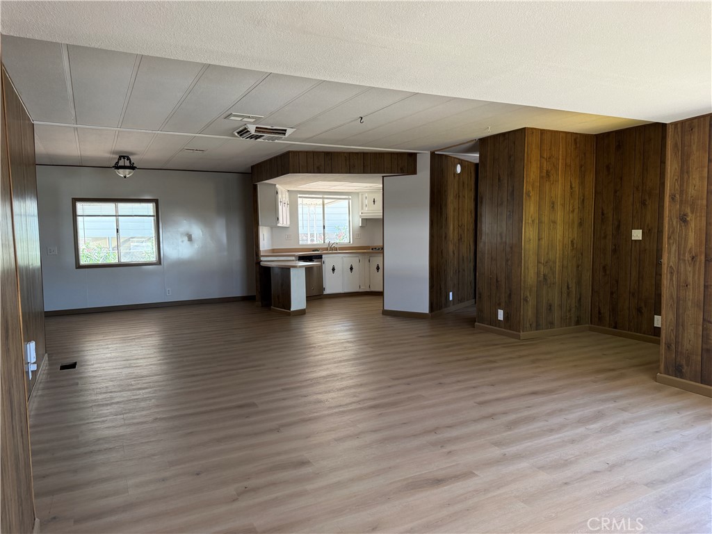 148600 Panoply Road Needles, CA 92363 - Photo 20 of 32 an empty room with wooden floor and windows