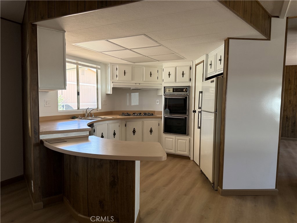 148600 Panoply Road Needles, CA 92363 - Photo 23 of 32 a kitchen with stainless steel appliances granite countertop a sink stove and refrigerator