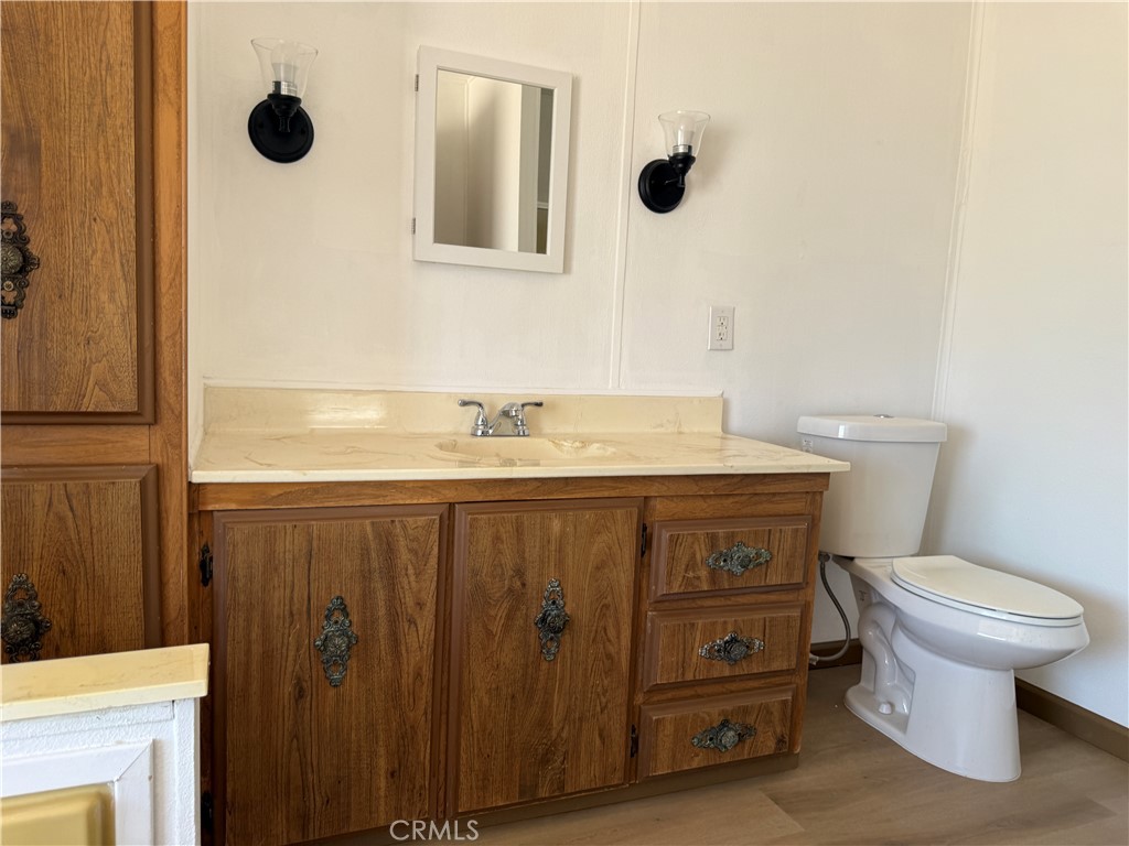 148600 Panoply Road Needles, CA 92363 - Photo 30 of 32 a bathroom with a sink a toilet and mirror