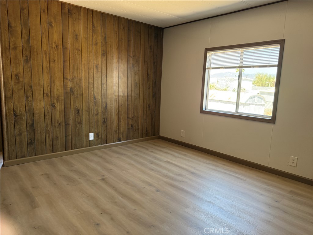 148600 Panoply Road Needles, CA 92363 - Photo 32 of 32 an empty room with wooden floor and windows