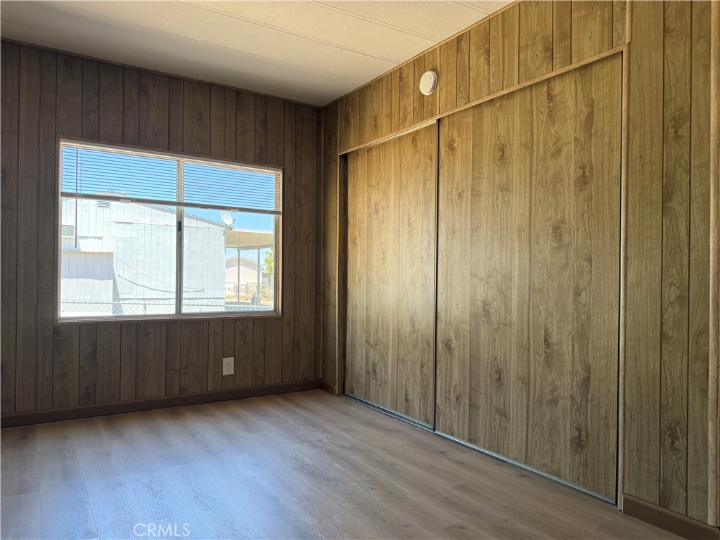 148600 Panoply Road Needles, CA 92363 - Photo 5 of 32 a view of an empty room with wooden floor and a window