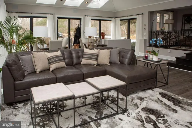 a living room with furniture potted plant and windows