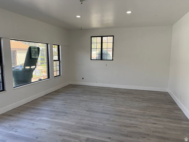 875 Cedar Hollow Road Lehi, UT 84043 - Photo 18 of 76 Spacious room featuring light wood-finish flooring, recessed lighting, and multiple windows with black trim