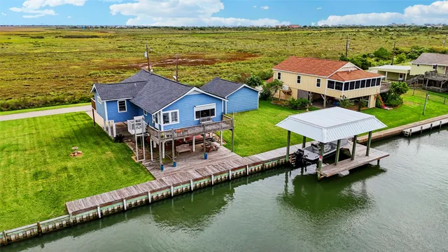 an aerial view of a house with a garden and lake view