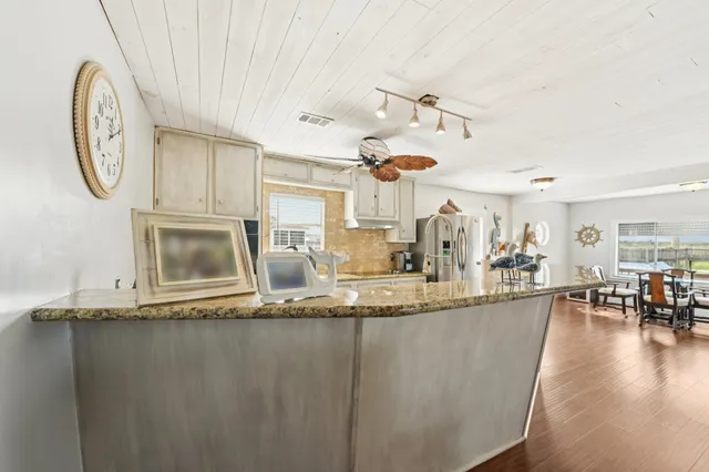 a large kitchen with a table and a large window