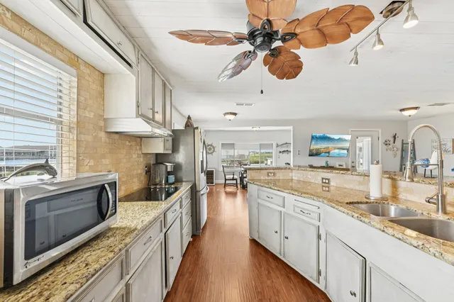 a kitchen with stainless steel appliances granite countertop a sink and cabinets