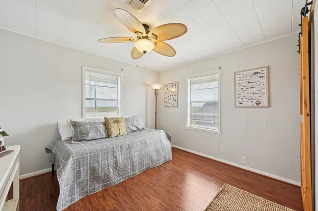 a bedroom with a large bed chandelier and a window