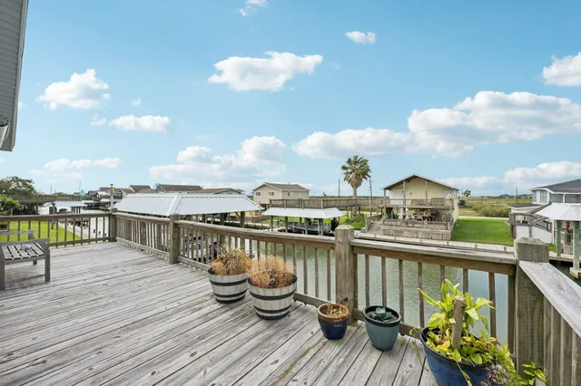 a view of a balcony with wooden chairs