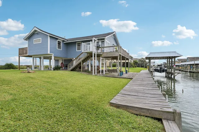 a view of a house with backyard porch and sitting area