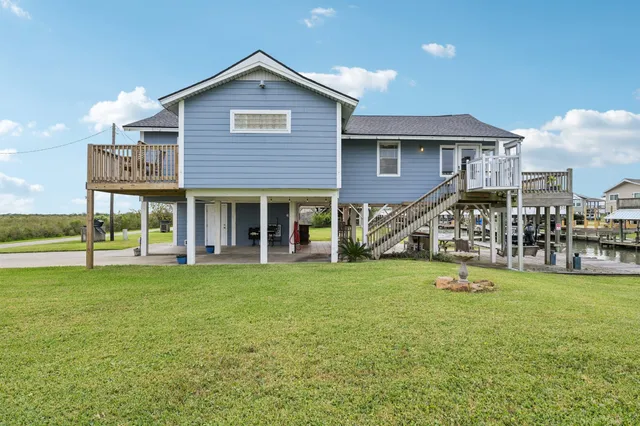 a view of a house with a yard and sitting area