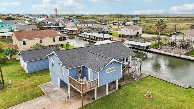 a aerial view of a house with swimming pool and ocean view