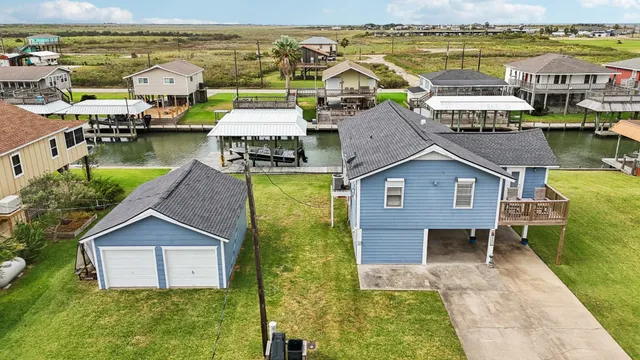 a aerial view of a house with swimming pool and lake view