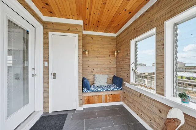 a room with a large window and a rug