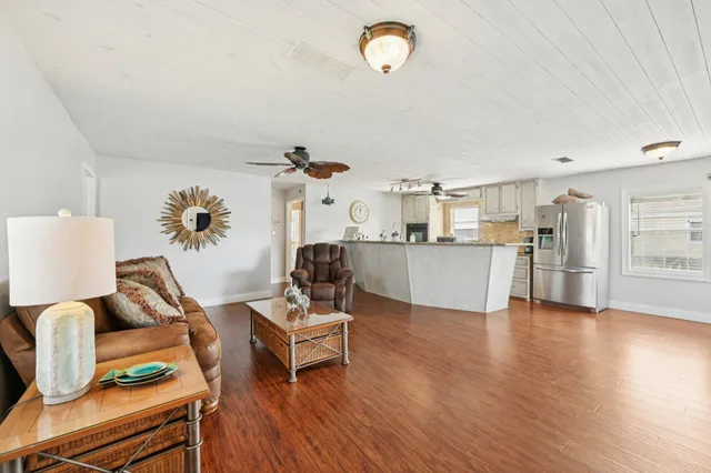 a living room with furniture and kitchen view