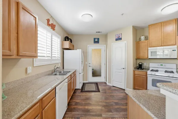 a kitchen with a sink stove and refrigerator