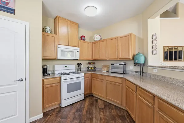 a kitchen with a sink cabinets and wooden floor