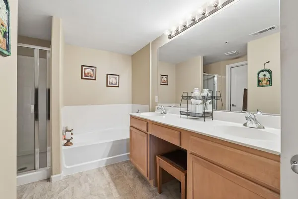 a bathroom with a tub sink and mirror